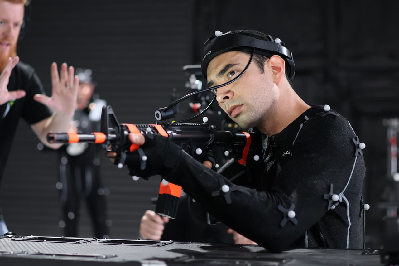 Performer in full-body OptiTrack motion capture suit with facial capture headset